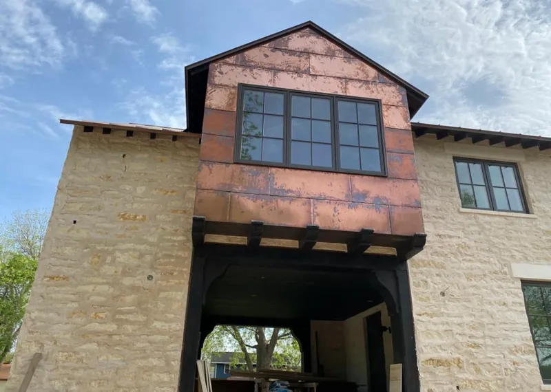 Copper metal panel facade on a stone building for Skylight Installation in Carlsbad